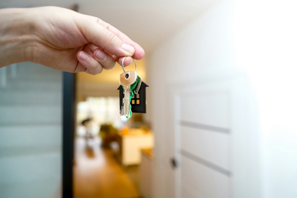 Keys being handed over at a front door