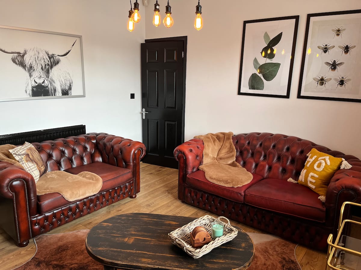 Lounge at the Royston villa, chesterfield sofas and pendant lights